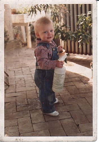 Mike Greenfield watering the plants as a young child